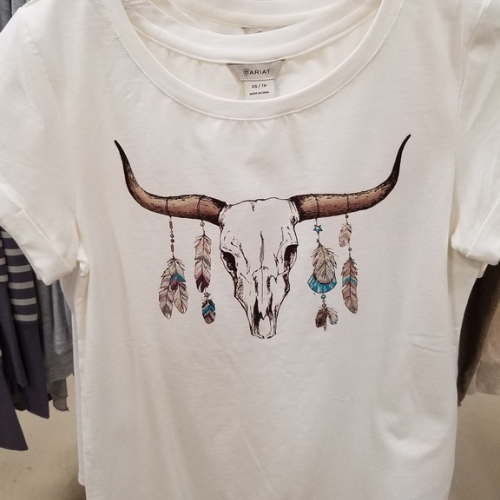 Womens shirt with a cow skull and feathers printed on it